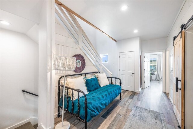 1002 State Highway 361, Port Aransas, TX 78373 - living area featuring a barn door, wood finished floors, recessed lighting, and vaulted ceiling