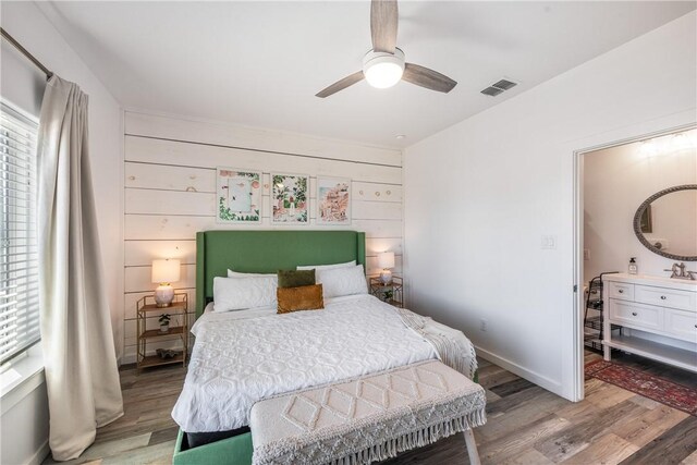 1002 State Highway 361, Port Aransas, TX 78373 - bedroom with light wood-style flooring, multiple windows, baseboards, and a ceiling fan