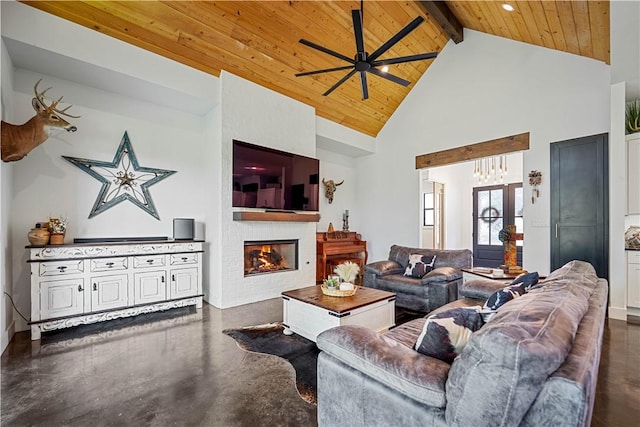 340 Warbler Dr, Spring Branch, TX 78070 - living area featuring wood ceiling with exposed beams, ceiling fan, high vaulted ceiling, a glass covered fireplace, and concrete floors
