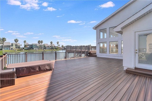 wooden terrace featuring a water view