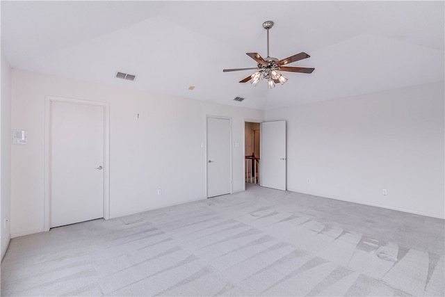 carpeted spare room with ceiling fan and lofted ceiling