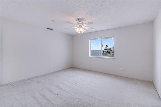 13714 A La Entrada St, Corpus Christi, TX 78418 - empty room featuring light colored carpet, ceiling fan, and a textured ceiling