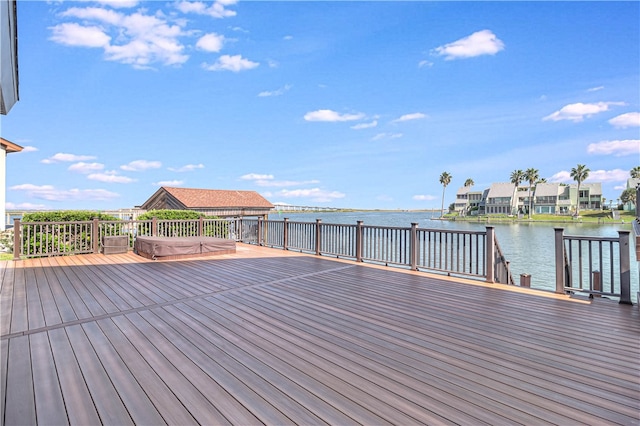 wooden terrace featuring a water view