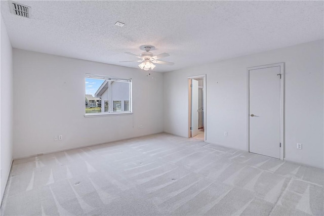 13714 A La Entrada St, Corpus Christi, TX 78418 - empty room with light colored carpet, ceiling fan, and a textured ceiling