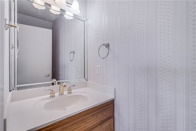 bathroom featuring vanity and a textured ceiling