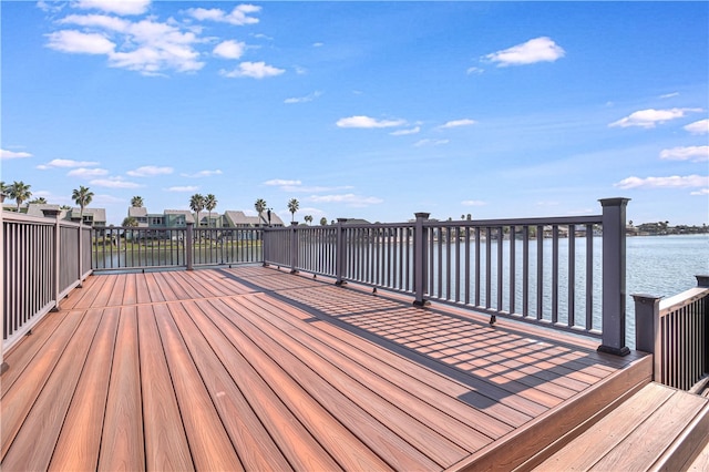 wooden terrace featuring a water view