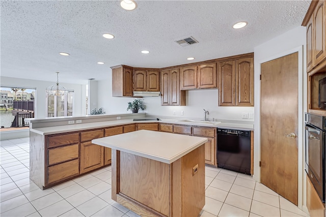 kitchen featuring a textured ceiling, black dishwasher, light tile patterned floors, hanging light fixtures, and sink