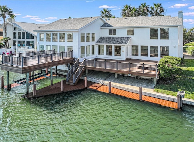 13714 A La Entrada St, Corpus Christi, TX 78418 - back of property with a chimney, stucco siding, a deck with water view, and a shingled roof