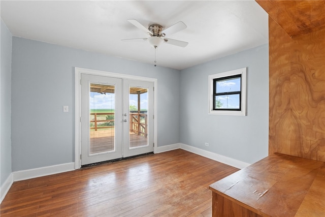 19838 County Road 1168, Mathis, TX 78368 - spare room featuring french doors, hardwood / wood-style flooring, baseboards, and ceiling fan