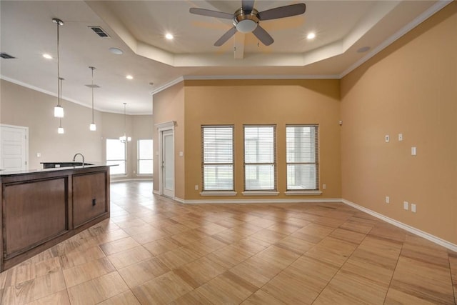 kitchen featuring open floor plan, crown molding, and a raised ceiling