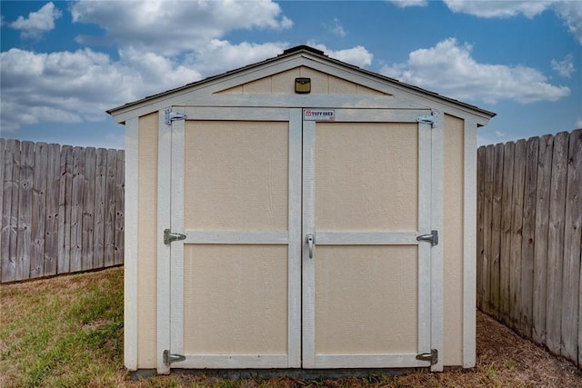 view of shed with fence