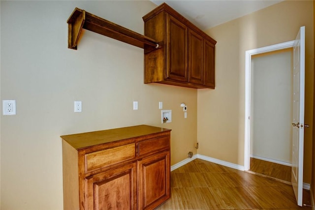 laundry area featuring hookup for a gas dryer, hookup for a washing machine, cabinet space, and baseboards