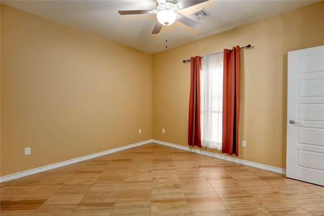 unfurnished room featuring ceiling fan, visible vents, and baseboards