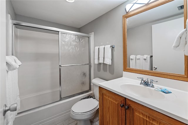 full bathroom featuring enclosed tub / shower combo, toilet, and vanity