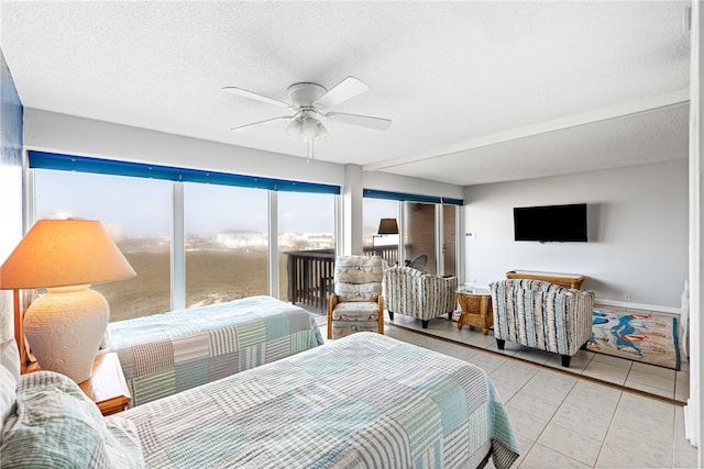 bedroom with access to exterior, a textured ceiling, ceiling fan, and light tile patterned floors