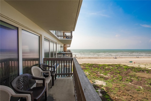 balcony with a view of the beach and a water view