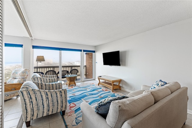 living room featuring a textured ceiling and light tile patterned floors