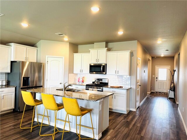 1353 Regents Park Ln, Corpus Christi, TX 78415 - kitchen featuring appliances with stainless steel finishes, a sink, tasteful backsplash, light stone counters, and recessed lighting