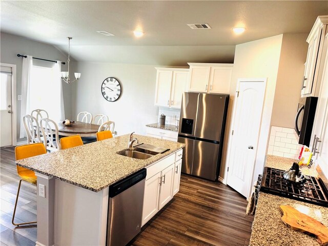 1353 Regents Park Ln, Corpus Christi, TX 78415 - kitchen featuring black appliances, a sink, a kitchen breakfast bar, dark wood-style floors, and vaulted ceiling