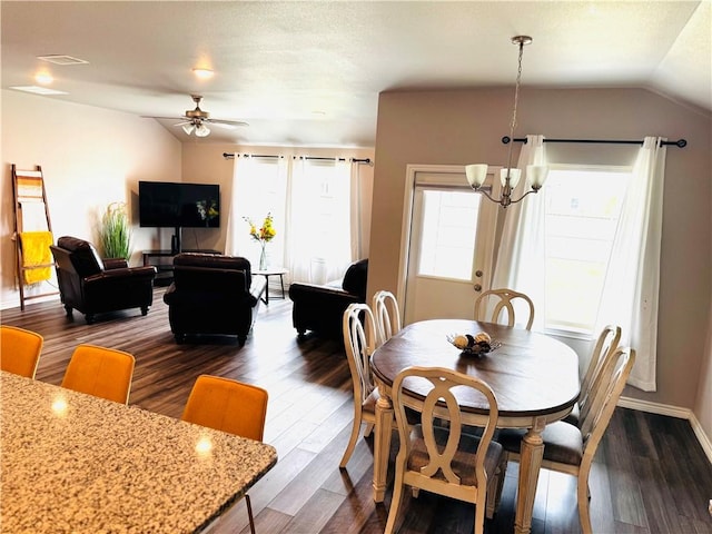 1353 Regents Park Ln, Corpus Christi, TX 78415 - dining area with lofted ceiling, ceiling fan, a chandelier, dark wood-style flooring, and baseboards