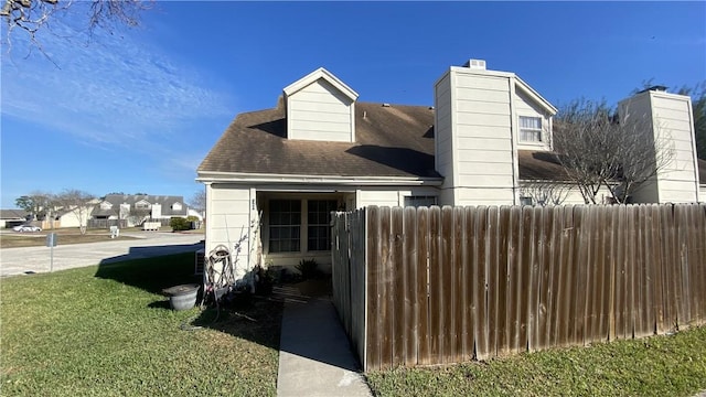 view of side of property with a lawn