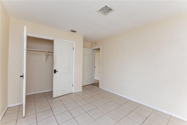 unfurnished bedroom featuring a closet and light tile patterned flooring