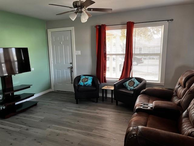 living room with hardwood / wood-style flooring and ceiling fan