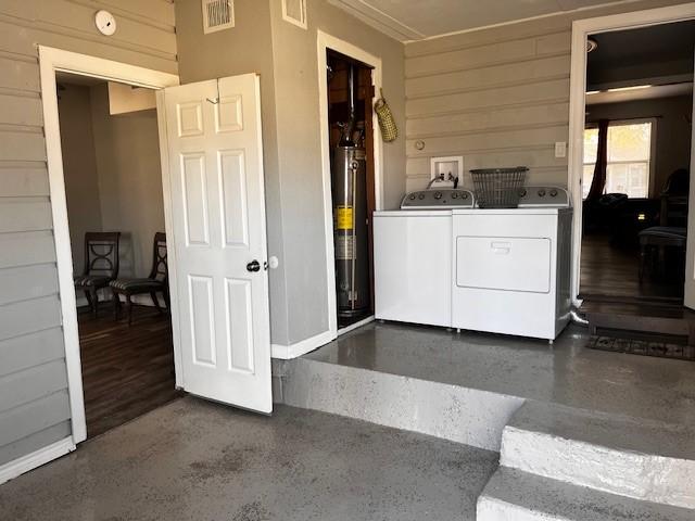 laundry area featuring separate washer and dryer and water heater