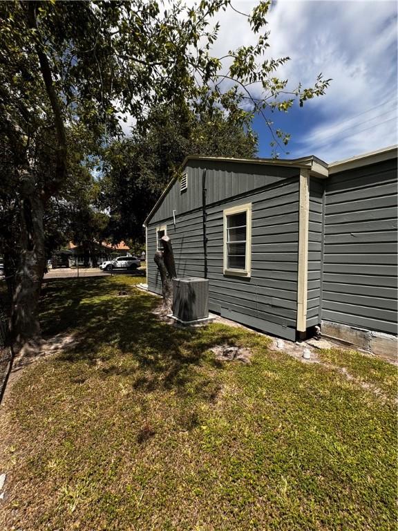 view of side of home featuring a lawn