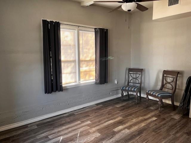 unfurnished room featuring beam ceiling, ceiling fan, and dark wood-type flooring