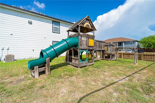 view of playground with central AC unit and a yard