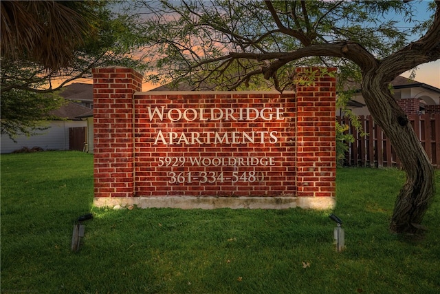 community sign featuring a lawn