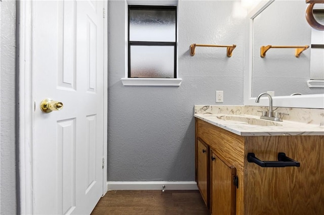 bathroom with vanity and hardwood / wood-style flooring