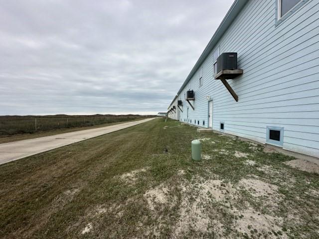 view of side of home with a yard