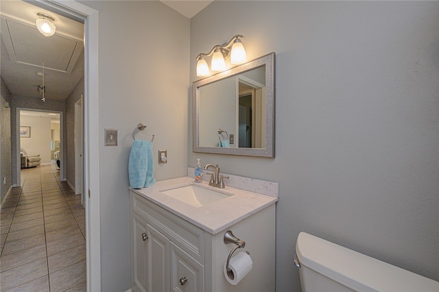 bathroom with tile patterned flooring, vanity, and toilet