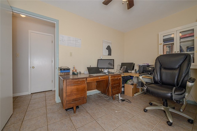 tiled office space featuring ceiling fan