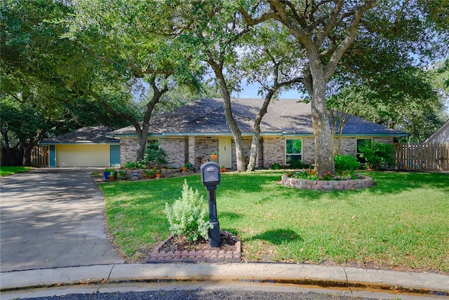 single story home featuring a garage and a front lawn