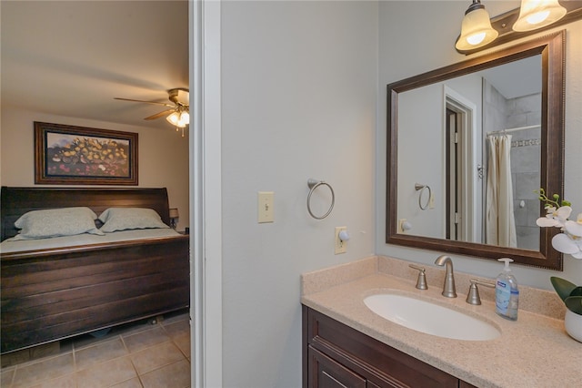 bathroom featuring vanity, a shower with shower curtain, tile patterned flooring, and ceiling fan