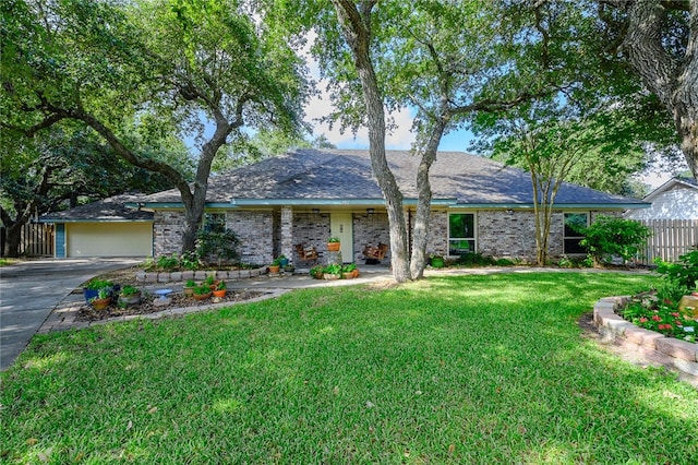 single story home featuring a garage and a front lawn