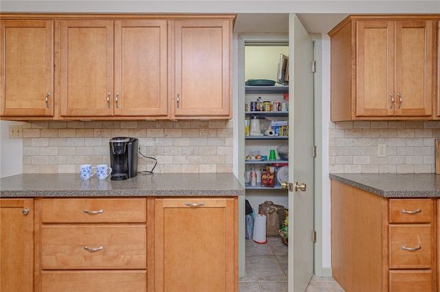 kitchen featuring light tile patterned flooring and decorative backsplash