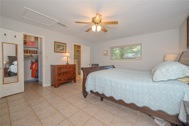 tiled bedroom featuring ceiling fan, a closet, and a spacious closet