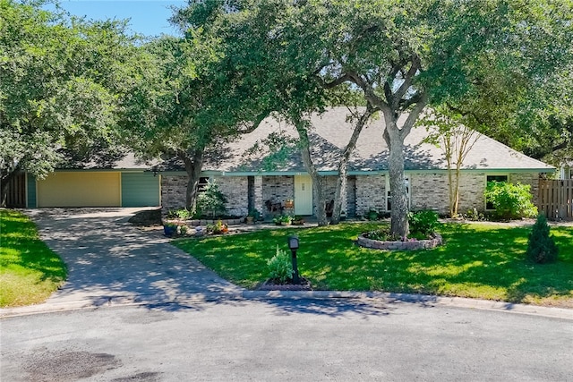 view of front facade with a front yard and a garage