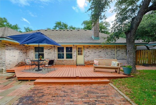 back of property with a wooden deck