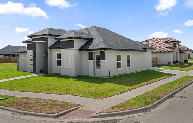 102 Prestwick Dr, Portland, TX 78374 - prairie-style home featuring a shingled roof, a front lawn, and stucco siding