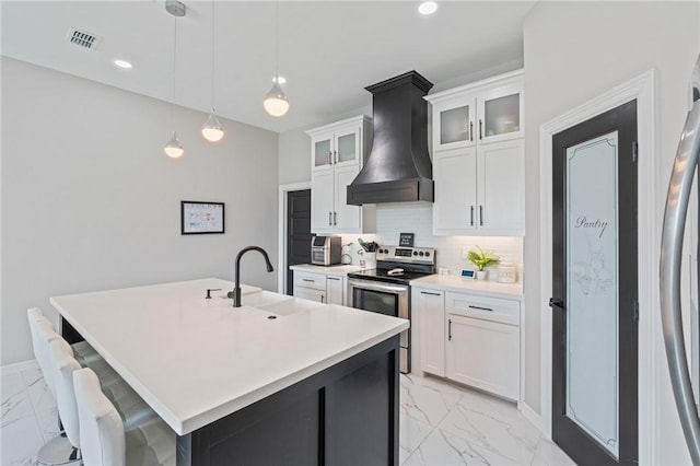 102 Prestwick Dr, Portland, TX 78374 - kitchen with a sink, marble finish floor, stainless steel appliances, custom range hood, and visible vents