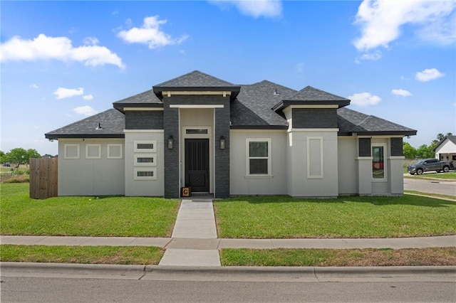 102 Prestwick Dr, Portland, TX 78374 - prairie-style home with roof with shingles, a front yard, stucco siding, and fence