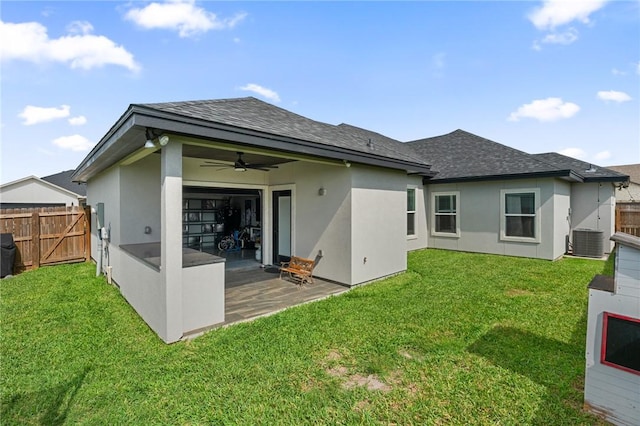 102 Prestwick Dr, Portland, TX 78374 - back of house with central AC, fence, ceiling fan, a yard, and stucco siding