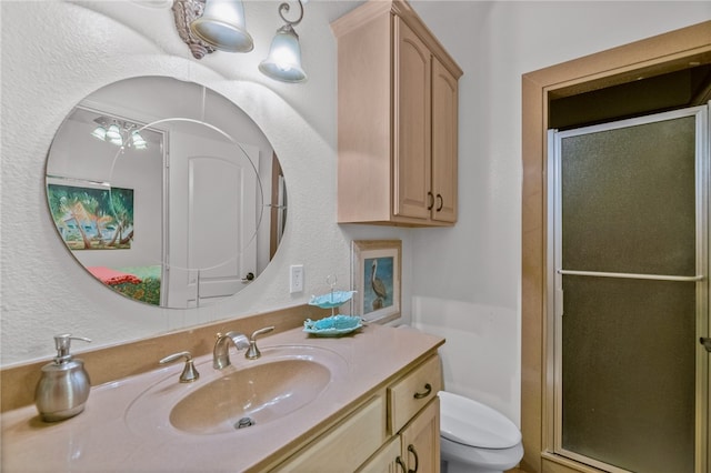 bathroom with vanity, toilet, and an enclosed shower