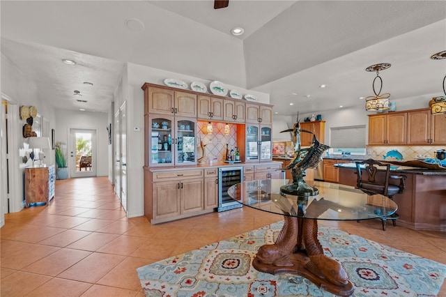 kitchen featuring light tile patterned flooring, beverage cooler, pendant lighting, and decorative backsplash