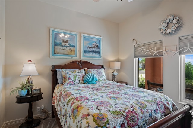 carpeted bedroom featuring multiple windows